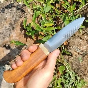 High carbon steel bushcraft knife with solid brass guard.