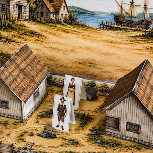 May include: A paper craft diorama set featuring two standing figures of individuals in colonial attire placed between two three-dimensional paper houses, set against a printed backdrop of a coastal village with a large sailing ship on the water.