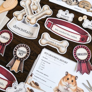 May include: A collection of pet grooming themed paper cutouts including bone-shaped labels with text like The bath station is downstairs, a red collar, award ribbons labelled Larger and Smaller, and a Pet Grooming Report sheet featuring a hamster.