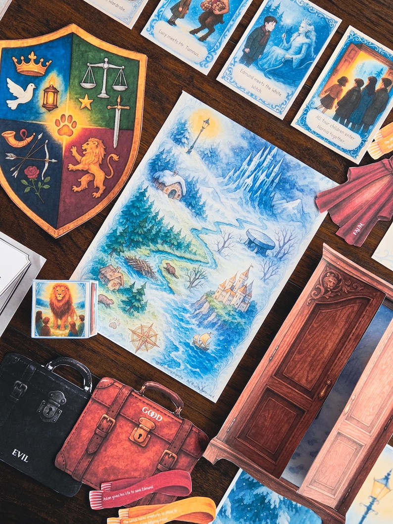 May include: A collection of illustrated cards and cutouts featuring a fantasy theme. Includes a map, a shield with symbols, suitcases labeled "EVIL" and "GOOD", and cards with text like "Lucy meets Mr. Tumnus".