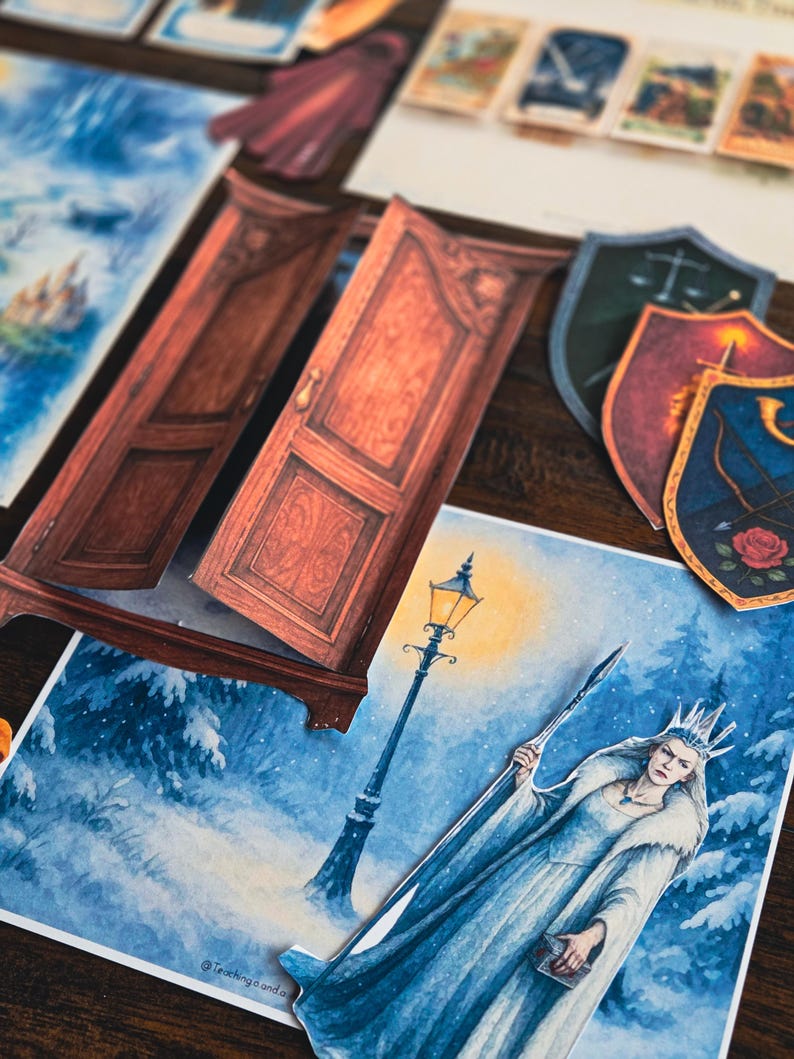 May include: A collection of fantasy-themed paper cutouts, including a wardrobe, shields, and illustrations of a winter scene with a queen and a lamppost. The color palette includes shades of brown, blue, and white.
