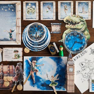 May include: A collection of Peter Pan-themed paper cutouts and decorations. Includes a clock, map, and illustrations of Peter Pan, Tinkerbell, and Captain Hook. The scene is set on a wooden surface, with a variety of props and imagery from the classic story.