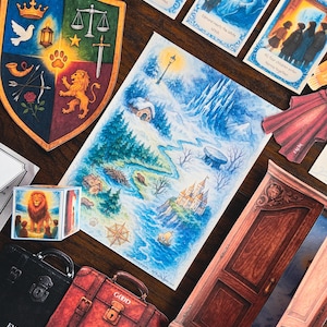 May include: A collection of illustrated cards, maps, and decorative items with a fantasy theme. Includes a shield with various symbols, a map of a snowy landscape, a red suitcase labeled "GOOD", and cards with text like "Lucy enters the wardrobe".