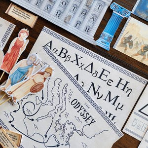 May include: Educational set featuring Greek alphabet letters, a map of The Odyssey, paper cutouts of Greek figures, and a building facade. Includes the text "A way of ruling where the people help make decisions and vote."