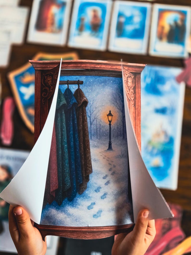 May include: A children's book illustration featuring a winter scene with a lamppost and footprints in the snow. The illustration is framed by a wooden border, with the pages partially open to reveal the artwork. Coats hang on a rack.