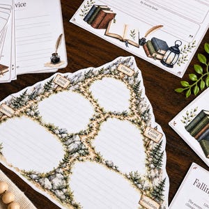 May include: A paper story plot diagram featuring a mountain path illustration with labeled sections for Exposition, Rising Action, Climax, Falling Action, and Resolution. The design includes rocky terrain, pine trees, and lined writing spaces.