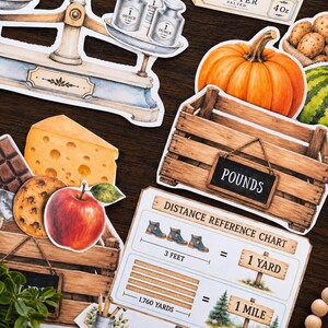 May include: A collection of die-cut stickers featuring a vintage balance scale with one-ounce weights, a box of salted butter, a pumpkin, a wooden crate labeled POUNDS, cheese, a chocolate bar, a cookie, an apple, and a distance reference chart.