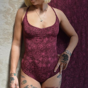 Las Flores Bodysuit - organic cotton bodysuit with cross back straps and beautiful floral print