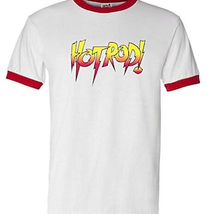 May include: White t-shirt with a red ringer and a yellow and orange graphic that says "HOTROD!"
