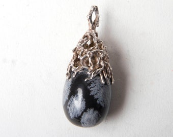 Silver encased snowflake obsidian pendant on silver chain