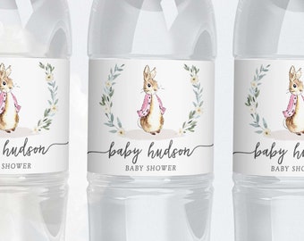 May include: Three clear plastic water bottles with labels featuring a watercolor illustration of a bunny wearing a pink jacket. The labels also include the text "baby hudson baby shower".