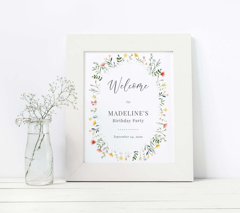 May include: A white framed welcome sign with a floral wreath border. The sign says "Welcome to Madeline's Birthday Party September 24, 2020".