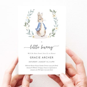 May include: A baby shower invitation with a watercolor illustration of a bunny rabbit wearing a blue jacket. The invitation reads "A little bunny" and includes the name "Gracie Archer" and the date "Saturday, August 12, 2-4pm".