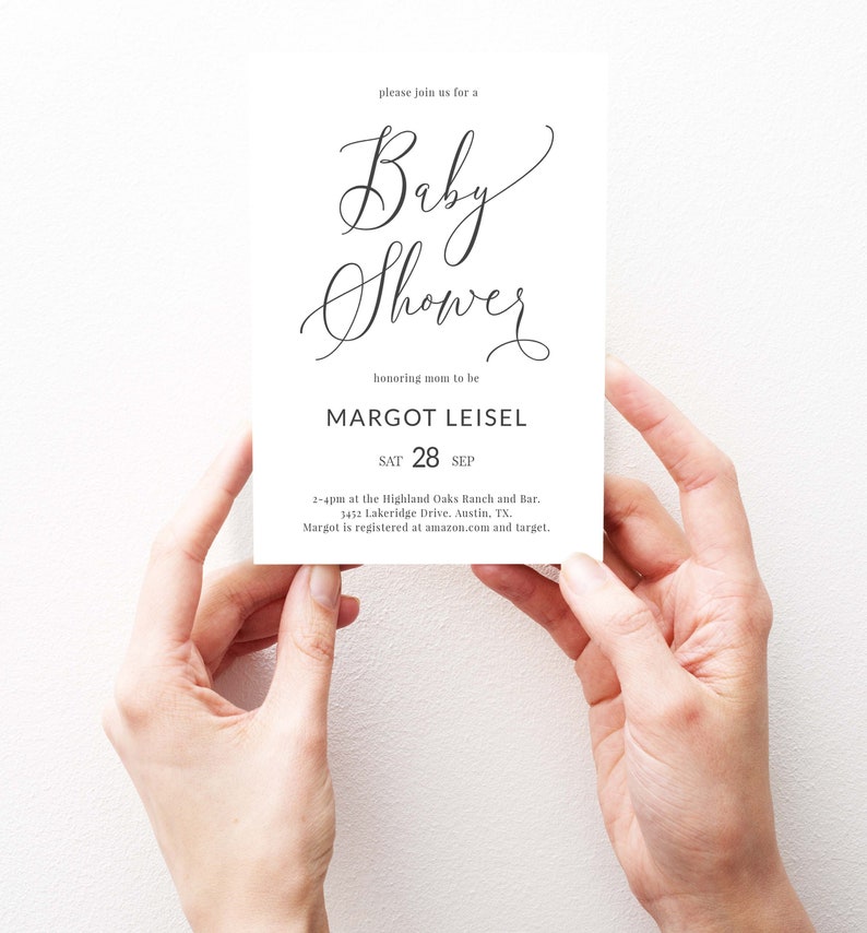 May include: A white baby shower invitation with black calligraphy text. The invitation reads "Please join us for a Baby Shower honoring mom to be Margot Leisel. Sat 28 Sep. 2-4pm at the Highland Oaks Ranch and Bar. 3452 Lakeridge Drive. Austin, TX. Margot is registered at amazon.com and target."