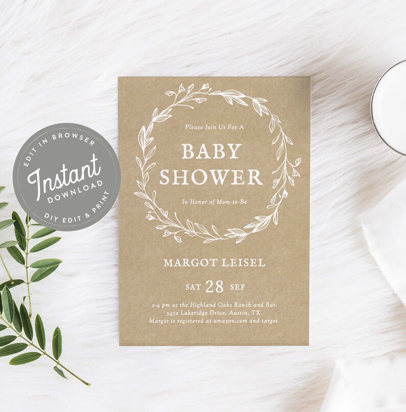 May include: A brown paper baby shower invitation with a white floral wreath and the text "Please Join Us For A Baby Shower In Honor of Mom-to-Be Margot Leisel Sat 28 Sep 2-4 pm at the Highland Oaks Ranch and Bar. 3452 Lakeridge Drive. Austin, TX. Margot is registered at amazon.com and target."