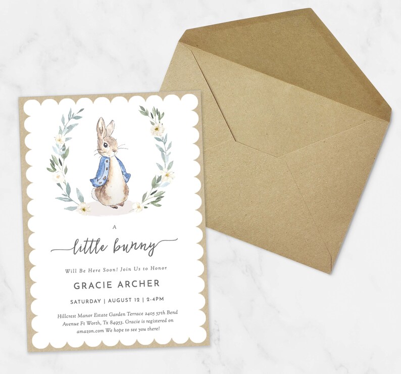 May include: A baby shower invitation with a watercolor illustration of Peter Rabbit in a blue jacket and a wreath of white flowers and green leaves. The text reads "A little bunny Will Be Here Soon! Join Us to Honor Gracie Archer Saturday August 12 | 2-4PM Hillcrest Manor Estate Garden Terrace 2405 37th Bend Avenue Ft Worth, Tx 84053. Gracie is registered on amazon.com We hope to see you there!"