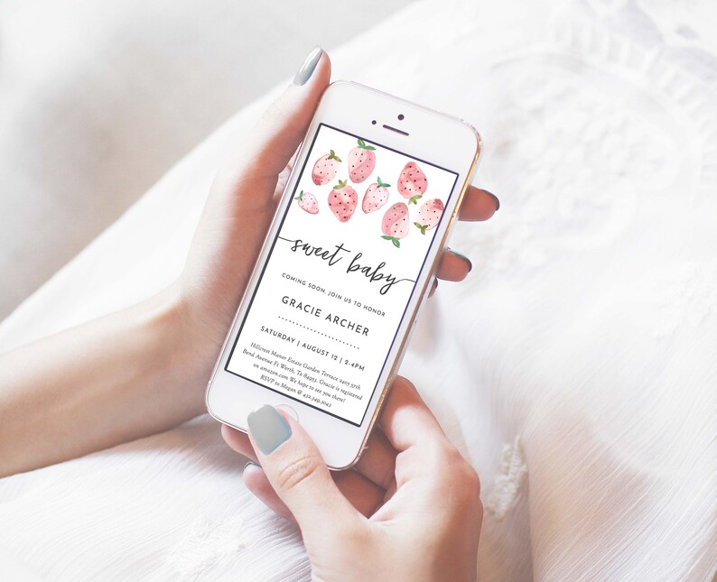 May include: A pink and white baby shower invitation on a smartphone screen. The invitation features a watercolor illustration of strawberries and the text "sweet baby" and "Gracie Archer". The date and time of the event are listed as "Saturday, August 12, 1-4 PM".