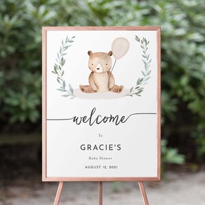 May include: Welcome sign for a baby shower with a watercolor illustration of a brown bear holding a balloon. The sign says "Welcome to Gracie's Baby Shower August 12, 2021".
