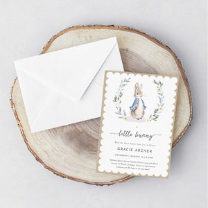 May include: A brown and white baby shower invitation with a watercolor illustration of Peter Rabbit. The invitation reads "A little bunny will be here soon! Join us to honor Gracie Archer, Saturday, August 12, 2-4pm, Hillcrest Manor Estate Garden Terrace, 5975 Band Avenue Ft Worth, TX. Ages: Gracie is registered on amazon.com. We hope to see you there!"