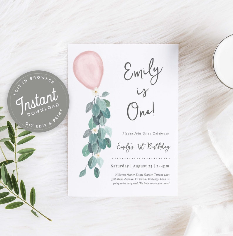 May include: A printable invitation for a first birthday party. The invitation features a pink balloon with a green eucalyptus garland and white flowers. The text on the invitation reads "Emily is One!" and includes the date, time, and location of the party.
