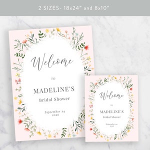 May include: Two printable bridal shower welcome signs with a floral wreath design. The signs are on a pink background and feature the text "Welcome to Madeline's Bridal Shower" and the date "September 24, 2020".