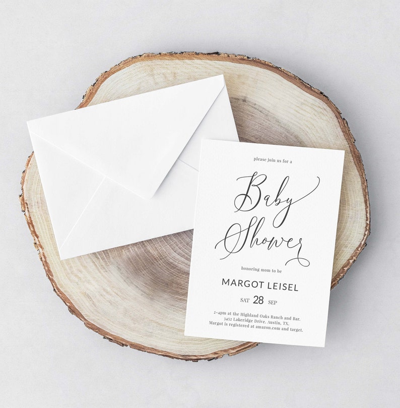 May include: A white card with black text announcing a baby shower for Margot Leisel on September 28th. The text reads "Please join us for a Baby Shower honoring mom to be Margot Leisel Sat 28 Sep 2-4pm at the Highland Oaks Ranch and Bar, 3417 Lakeridge Drive, Austin, TX. Margot is registered at amazon.com and target."