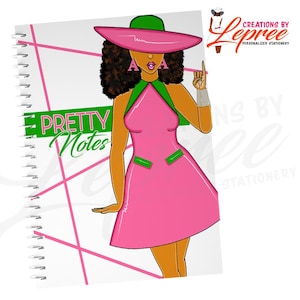 May include: Spiral-bound notebook with a colorful illustration. The cover features a cartoon woman in a pink dress and hat, with the text "PRETTY Notes" in green. Pink diagonal lines and the letters "AKA" are also visible.