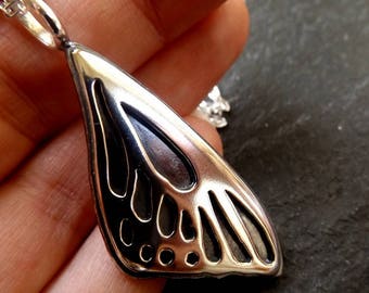 Silver Butterfly wing necklace pendant with oxidized background