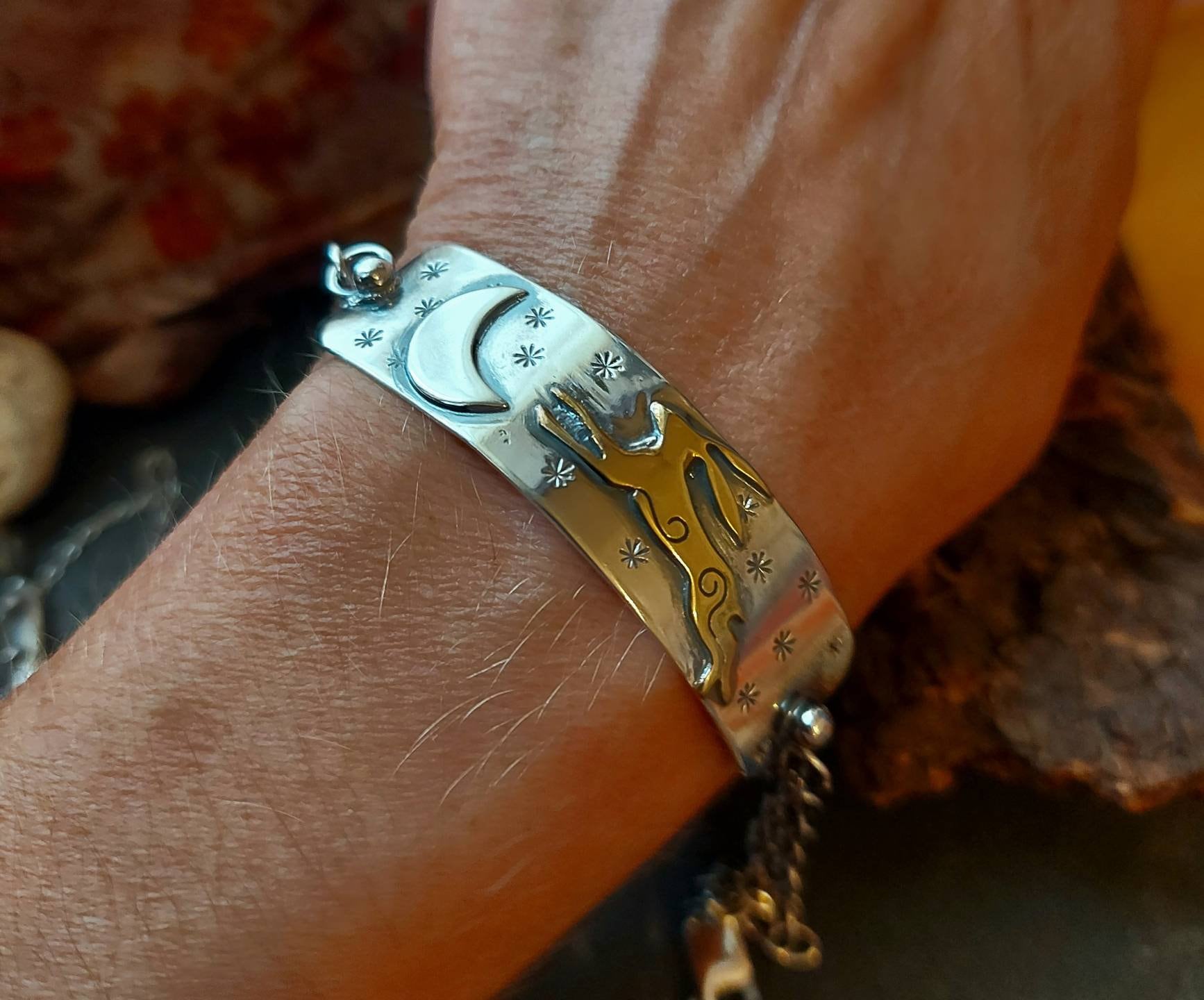 Silver leaping hare with Moon and Stars bar bracelet with star and moon charms, and brass hare