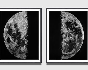May include: Two framed black and white prints of the moon. Each print shows a detailed view of a half-moon, with visible craters and textures. The prints are displayed against a neutral background.