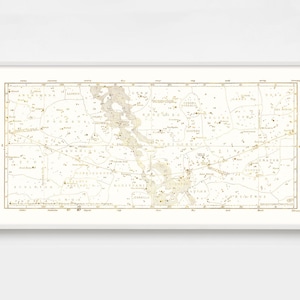May include: A vintage star chart with constellations outlined in gold on a white background. The constellations include Aquarius, Cetus, Eridanus, Fornax, and more. The chart is framed in a white frame.