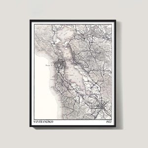 May include: Black framed vintage map print of San Francisco, California, from 1922. The detailed black and white map shows the city's layout, roads, and surrounding areas, including the San Francisco Bay. The text "SAN FRANCISCO" and "1922" are visible.
