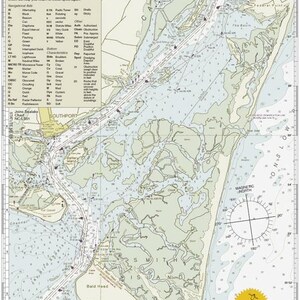 May include: A detailed nautical chart titled "Cape Fear River" with navigational aids, depth soundings, and a compass rose. The chart includes the text "Waterway Fishing Guide" and features the Bald Head Island area.