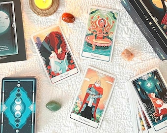 May include: A selection of tarot cards and associated items displayed on a white cloth. The cards have vibrant illustrations, and are alongside a box, candles, crystals, and a book. The overall theme is mystical and spiritual.