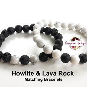 May include: Two matching bracelets, one with black lava rock beads and the other with white howlite beads. The bracelets are intertwined and the text "Howlite & Lava Rock Matching Bracelets" is below them.