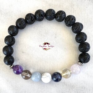 May include: A black lava rock bracelet with amethyst, clear quartz, blue lace agate, white howlite, lapis lazuli, citrine, and rose quartz beads.