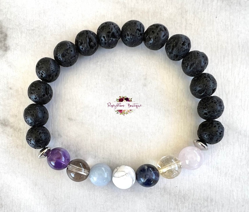 May include: A black lava rock bracelet with amethyst, clear quartz, blue lace agate, white howlite, lapis lazuli, citrine, and rose quartz beads.