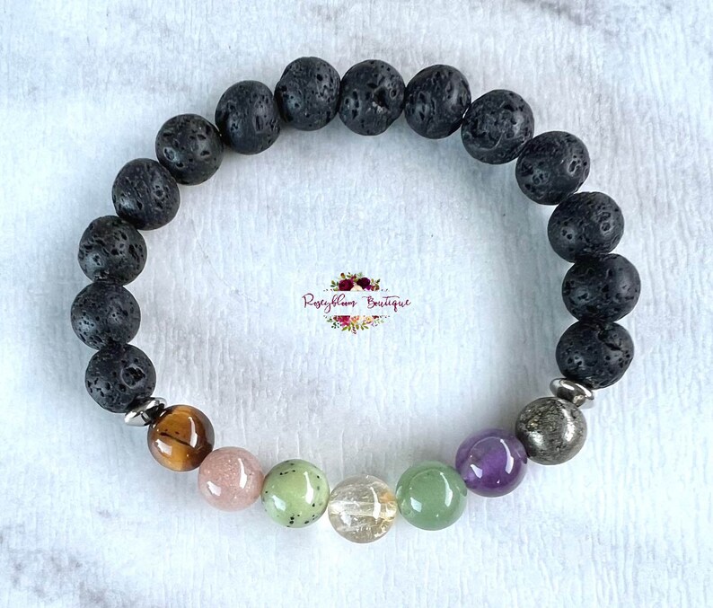 Puede incluir: Un brazalete de roca de lava negra con ojo de tigre marr&oacute;n, cuarzo rosa rosa, aventurina verde, cuarzo transparente y amatista. El brazalete tambi&eacute;n incluye separadores de metal plateado.
