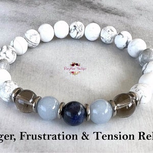 May include: White Howlite and Smoky Quartz beaded bracelet with a blue Lapis Lazuli bead. The bracelet is designed to help with anger, frustration, and tension relief.