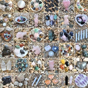 May include: Assortment of crystals, stones, and figurines arranged on a white background. The items include a variety of colors, shapes, and sizes. Some of the items are labeled with words like "Love" and "Happy".