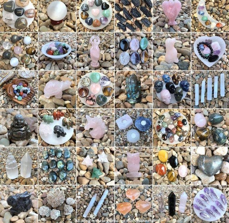 May include: Assortment of crystals, stones, and figurines arranged on a white background. The items include a variety of colors, shapes, and sizes. Some of the items are labeled with words like "Love" and "Happy".