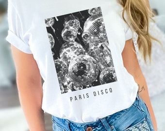 May include: White t-shirt with a black and white graphic of disco balls and the text "PARIS DISCO" printed on the front.