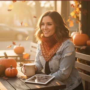 May include: A woman wearing a denim jacket and an orange scarf, holding a mug, with pumpkins and falling leaves on a wooden table. The image has text that reads "Autumn's Embrace: Cozy Chic Pumpkin Spice Perfection" and "Shop Now".