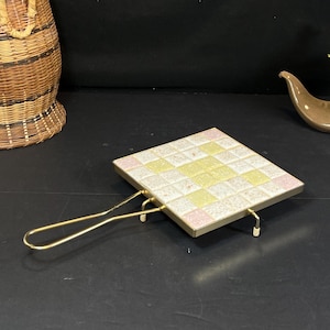 May include: A set of three ceramic mugs with a speckled, matte finish. The mugs are in shades of cream, light gray, and dark gray. Each mug has a simple, minimalist design and a rounded handle.