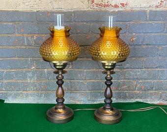 A Pair of Plymouth Harlee Mid Century Wooden Electric Hurricane Lamps with Amber Glass Shades