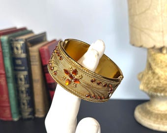 Gold Tone Metal Hinged Bracelet with Amber Rhinestones