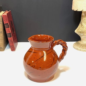 May include: A rustic wooden sign with the text "Welcome to our home" in white lettering. The sign features a distressed finish and a simple, inviting design, perfect for entryway decor.