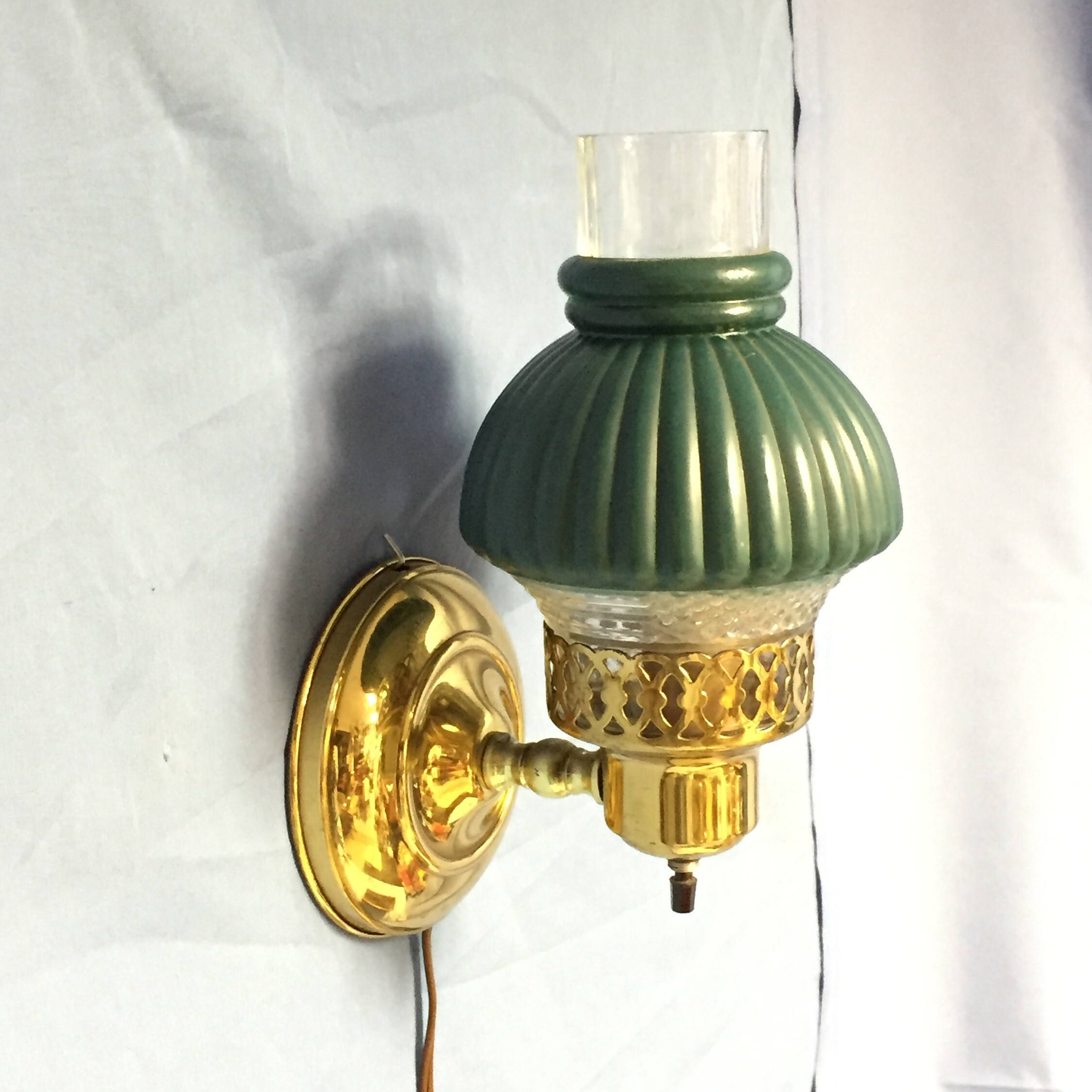 Vintage Mid Century Brass Tone Electric Hurricane Wall Sconce with a