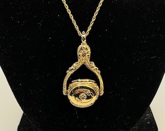 1928 Gold Tone Necklace with 3 Sided, Spinning Locket Pendant with Etched Floral Design