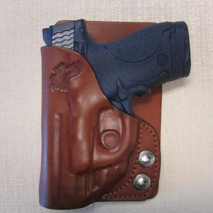 Smith and Wesson M & P shield 9 mm and 40 cal.. with Crimson trace trigger guard laser right hand BROWN leather wallet and pocket holster